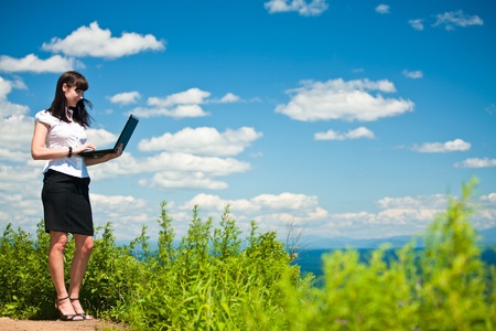 beautiful girl in a business suit with laptopの写真素材
