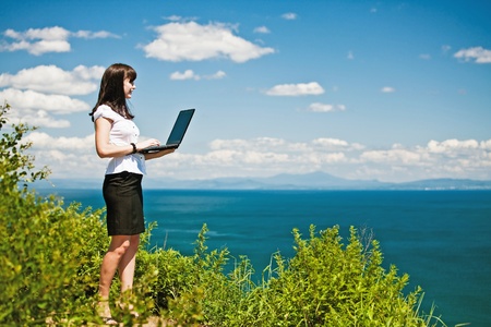 beautiful girl in a business suit with laptopの写真素材