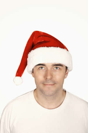 A young man with a beard in a red Christmas hatの写真素材