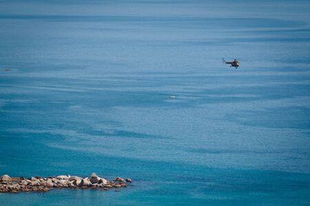 helicopter flight over the people relaxing on the beach