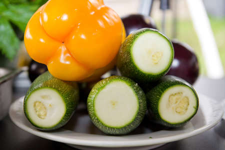 Fresh zucchini and peppers on a plateの写真素材
