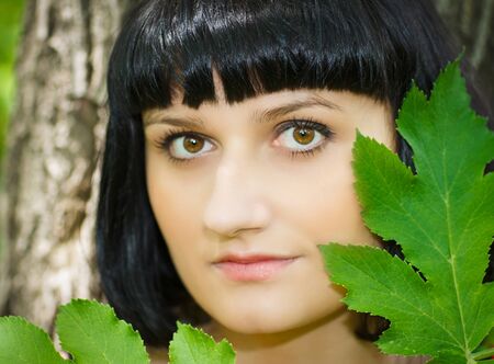 Environmental portrait of a girl with a blade of grassの写真素材