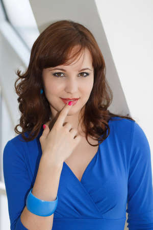 portrait of a girl with dark hair in a white studioの写真素材