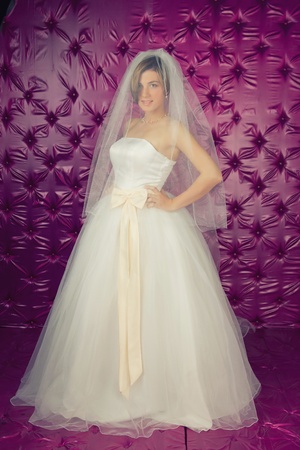 a beautiful young bride in a pink studioの写真素材