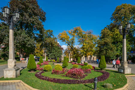 Kislovodsk, Russia - September 2019: Resort park - flowerbed with flowers, lanterns, people walk along the alleyのeditorial素材