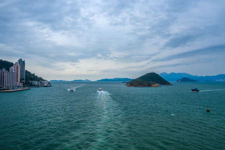 Seascape, coast with skyscrapers, islands and boats