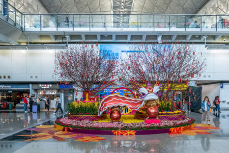 Hong Kong, China - 2020: Hong Kong International Airport from the inside. Chinese New Year. The figures of mice - symbols of the year, the trees are decorated with chinese lanterns.のeditorial素材