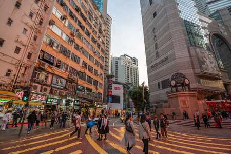 Hong Kong - 2020: people at crosswalk near Times Square mall, intersection of Matheson Street and Russell Street.のeditorial素材