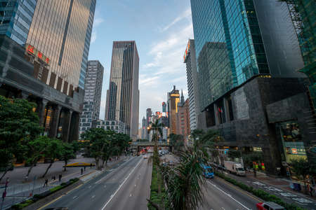 Hong Kong - 2020: Gloucester Road from above, street with palm trees and flower beds. Facades of office buildings. Skyscrapers of Hong Kong.のeditorial素材