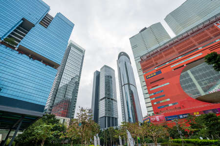 Hong Kong - 2020: skyscrapers facade - Exchange Tower, One Kowloon, Manhattan Place and Enterprises Square I, II, III, MegaBox mall. View from Zero Carbon Park.のeditorial素材