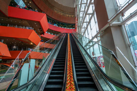 Hong Kong - 2020: escalator in MegaBox shopping center, without people, interior, empty escalator with glass railing.のeditorial素材