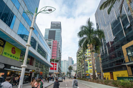 Hong Kong - 2020: Sheung Yuet Road, people on the street, buildings facades.のeditorial素材