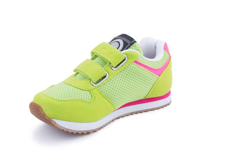 One colorful bright green leather fiber, fabric breathing children laced orthopedic footwear snickers shoe boot isolatedの写真素材