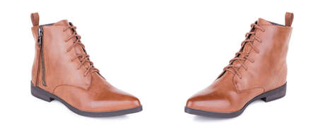 Pair of stylish classical brown woman leather high ankle boots shoes. Two isolated.の写真素材