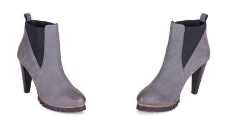 Pair of stylish classical grey woman suede leather high ankle boots shoes. Two isolated.の写真素材