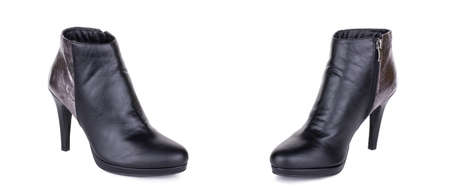 Pair of stylish classical black woman leather high ankle boots shoes. Two isolated.の写真素材
