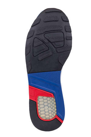 Sole of sport tracking shoes snickers individual design close up isolated one stylish and bright red, blue and black patternの写真素材