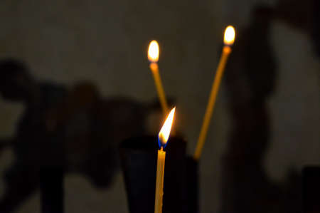 A close-up of a candle in an old churchの写真素材