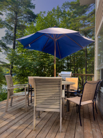 Outdoor patio with tables and chairs on the deck of a cottageの写真素材