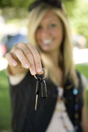 Model Release 358  Teenage girl holding out the keys to her carの写真素材