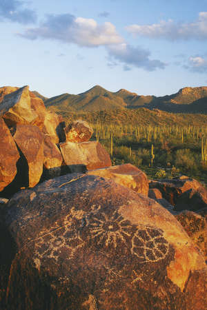 Petroglyphs on Signal Hill with the Tuson Mountaians in the background. Saguaro National Park, Arizona...The petroglyphs were most likely created by the Hohokam People between 700 and 1300 years agoの写真素材