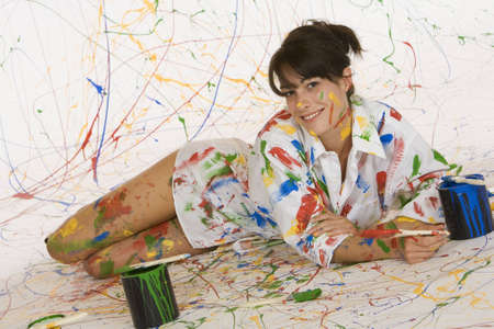 Model Release 353  Woman in mid 20s having fun making a mess paintingの写真素材