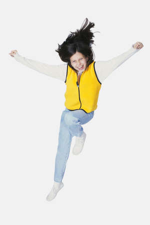 Preteen jumping on white backgroundの写真素材