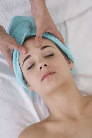 Young woman having a relaxing moment during a messageの写真素材