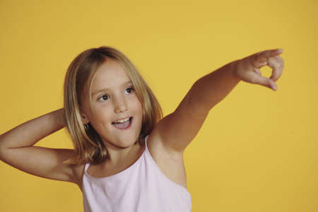 Eight year old girl pointingの写真素材