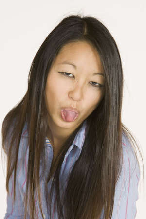 Asian woman sticking out tongueの写真素材