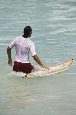 Brazilian man surfing on Copacabana Beach in Rio de Janeiro in Brazil