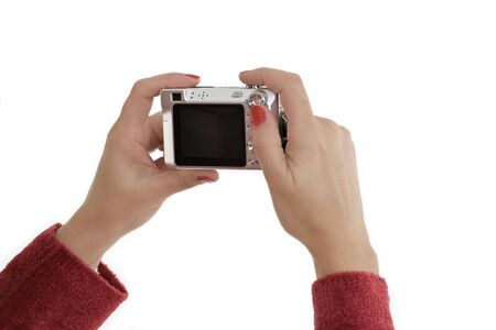 Caucasian female holding up a Point and Shoot digital camera to take a photographの写真素材