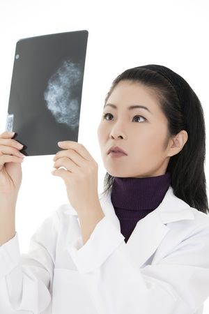 Beautiful Asian doctor reading an x-ray of aの写真素材