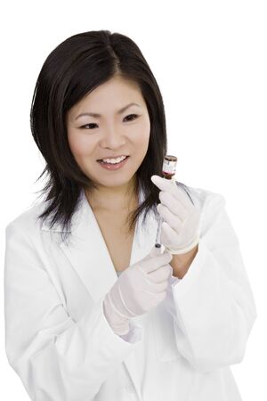 Beautiful Asian doctor or nurse preparing a vaccinationの写真素材