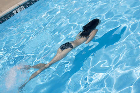 Beautiful Caucasian woman enjoying a day at the poolの写真素材