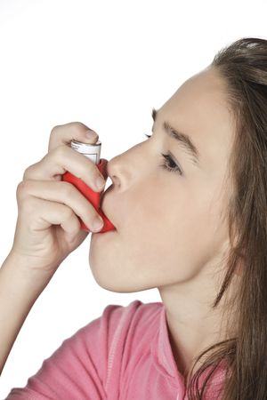 Cute Caucasian girl using an inhaler for Asthmaの写真素材