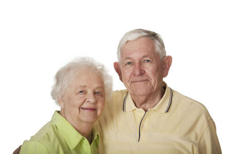 Happy elderly Caucasian couple posing on white background.