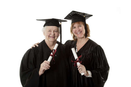 Beauitiful Caucasian mother and daughter in black graduation gownの写真素材