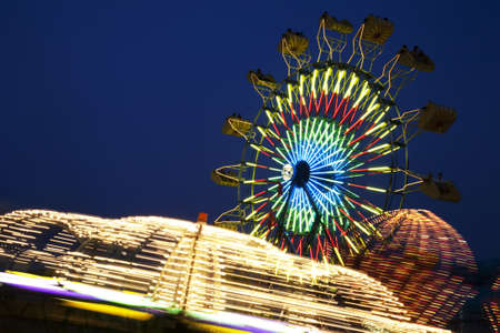 Amusement Rides with Movement Blur in the evening at the Kentucky State Fair Midway Louisville Kentuckyの写真素材
