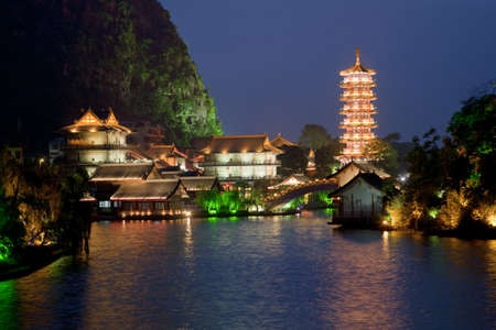 Mulong Pagoda also known as the Mulong Tower reflected in the Mulong Lake,  Mulong Lake Park, Guilin, Chinaの写真素材