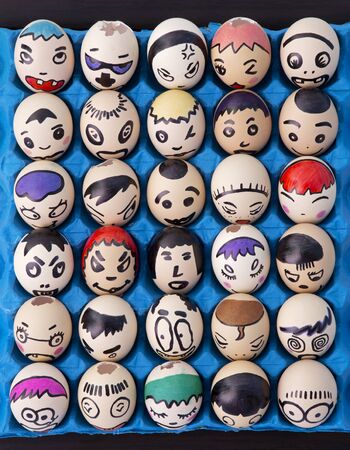 Kindergarten Children's craft of faces painted on eggsの写真素材