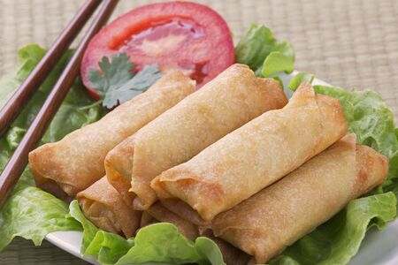 Traditional Chinese Spring Rolls on a bed of lettuceの写真素材