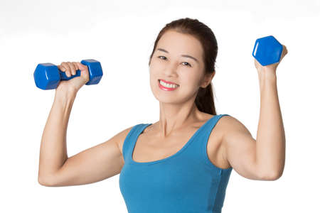 Beautiful Asian woman working out using dumbbell weights isolated on a white backgroundの写真素材