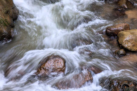 Water flowing around rocks in Roaring Fork Creek along the Roaring Fork Motor Tour in the Great Smoky Mountains National Park Tennessee USAの写真素材