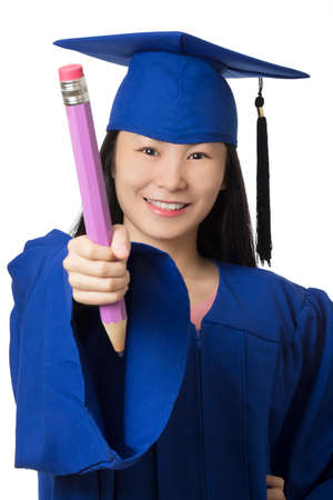 Asian woman dressed in a blue graduation gown holding a gaint pencil isolated on white background