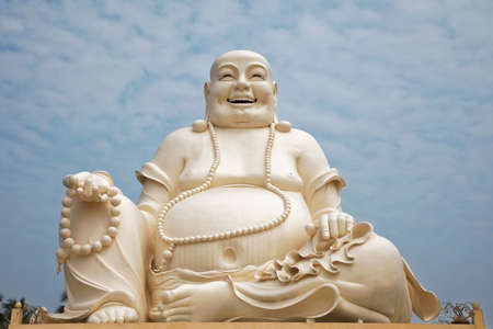Sitting Buddha statue at the Vinh Trang Temple in Mytho City, Mekong Delta, Vietnamの写真素材
