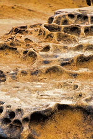 Honeycomb weathering patterns in the limestone within the Yehliu Geological Park known to geologists as the Yehliu Promontory, forms part of the Daliao Miocene Formation. New Taipei, Taiwan, Chinaの写真素材