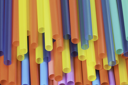 A background of colorful plastic straws used to illustrate plastic pollutionの写真素材
