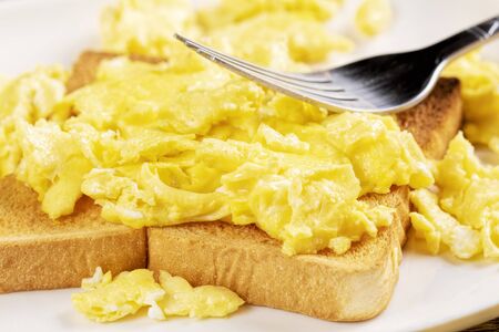 A delicious breakfast of scrambled eggs and toast with copy space