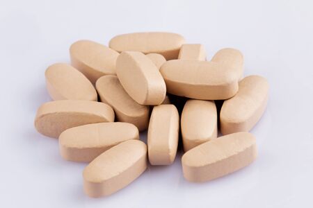 Close up of Multi-Vitamin and mineral on a white background with shallow Depth of field